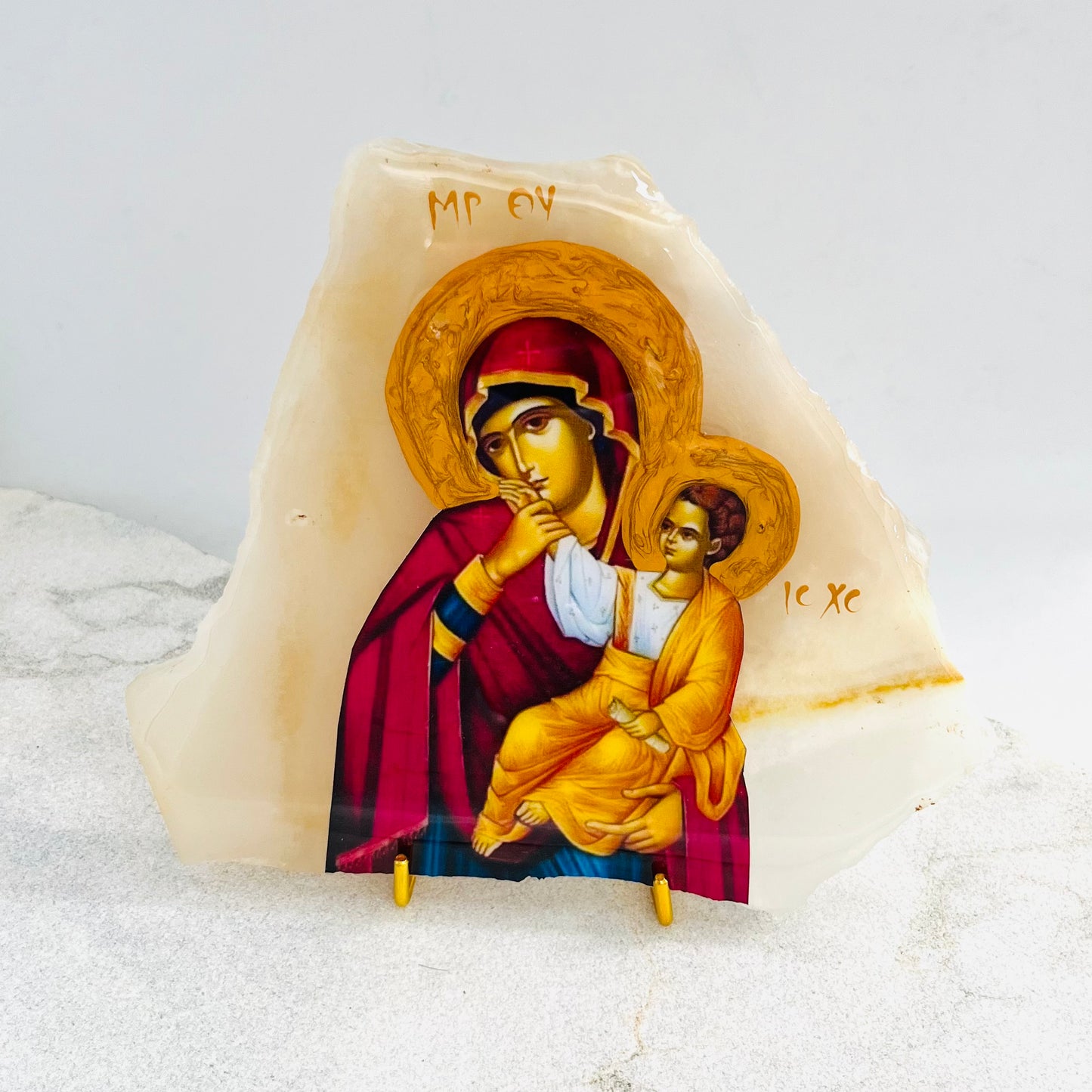 Panayia / Mary, Mother of Jesus icon is carefully handcrafted on Onyx covered with a clear hypoxy resin.  Comes with a gold stand.
