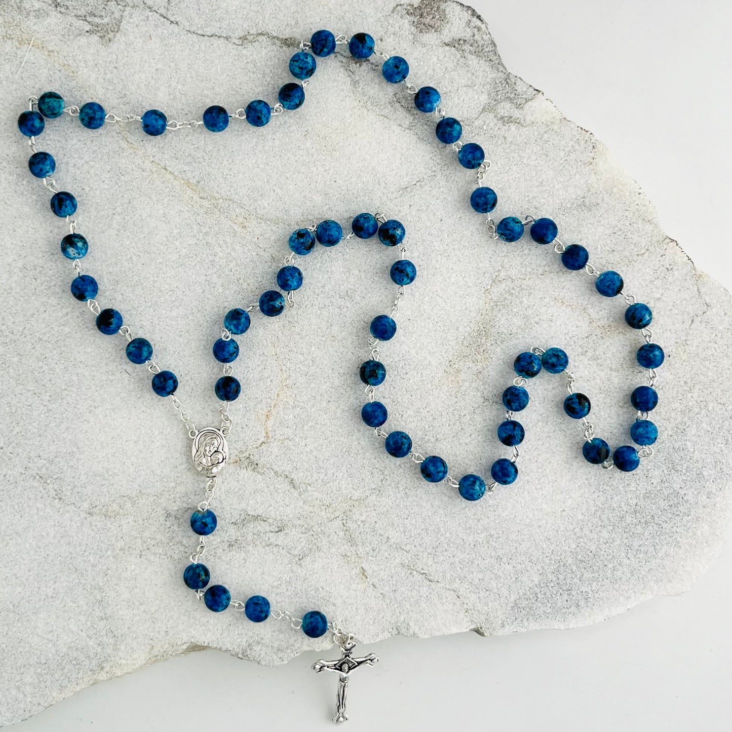 These beautiful Blue Rosary are handcrafted in Jerusalem and contain a small capsule of Holy Earth from the Holy Land. Each bead is a reminder of prayer, devotion, and the sacred ground where Christ walked. Ideal for daily prayer or as a meaningful gift, this rosary connects the faithful to the spiritual heart of Christianity.